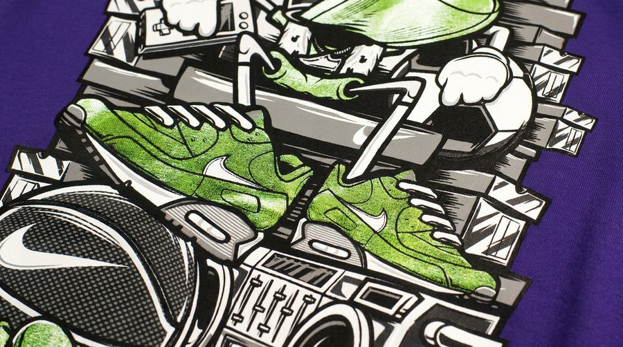 Green and white Pigmento ink on a purple tee — vivid graffiti character print with no fabric showing through